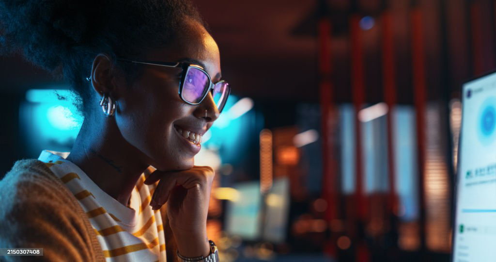 Woman smiling looking at a screen